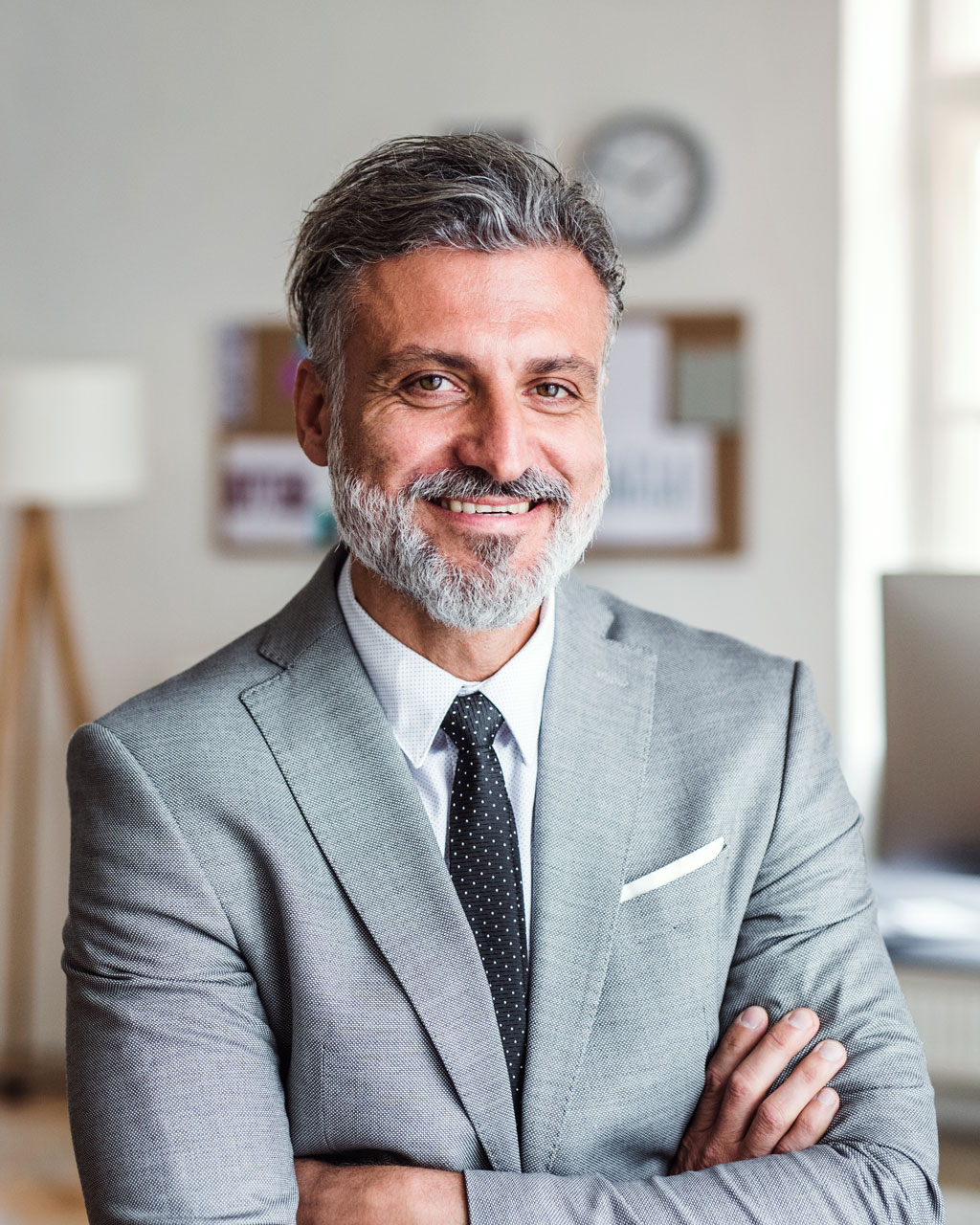 mature-businessman-standing-in-an-office-arms-cros-3A5WZ92.jpg